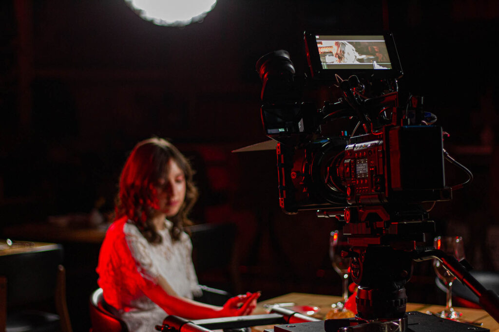 Izabel Joy on set with camera in foreground